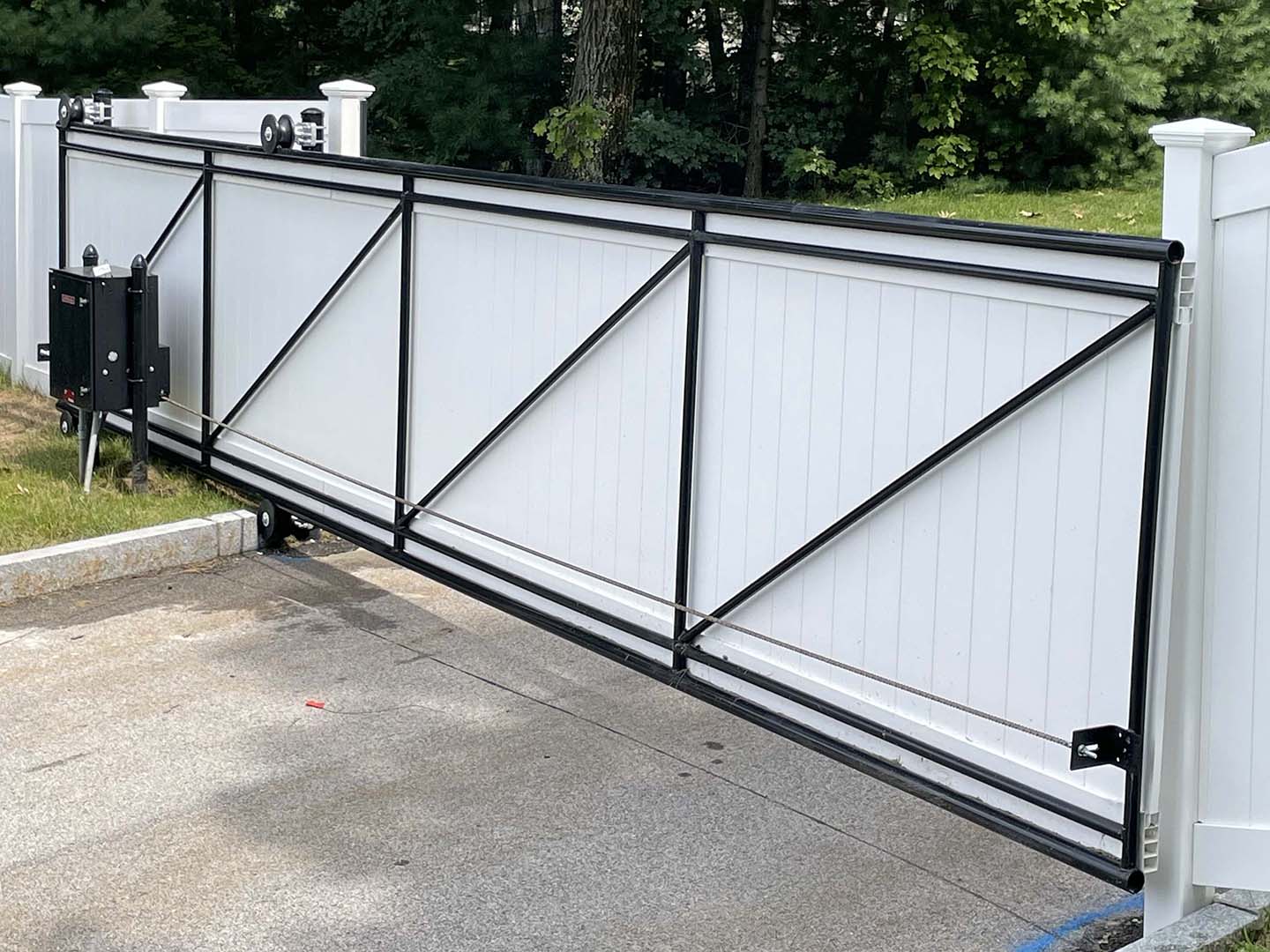 Cantilever slide gate and operator installed on a commercial driveway in the Merrimack Valley, Massachusetts