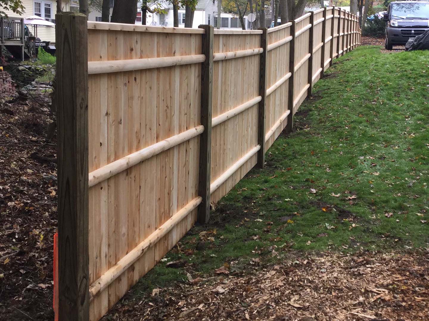 Completed cedar fence installation photographed in the Merrimack Valley, Massachusetts